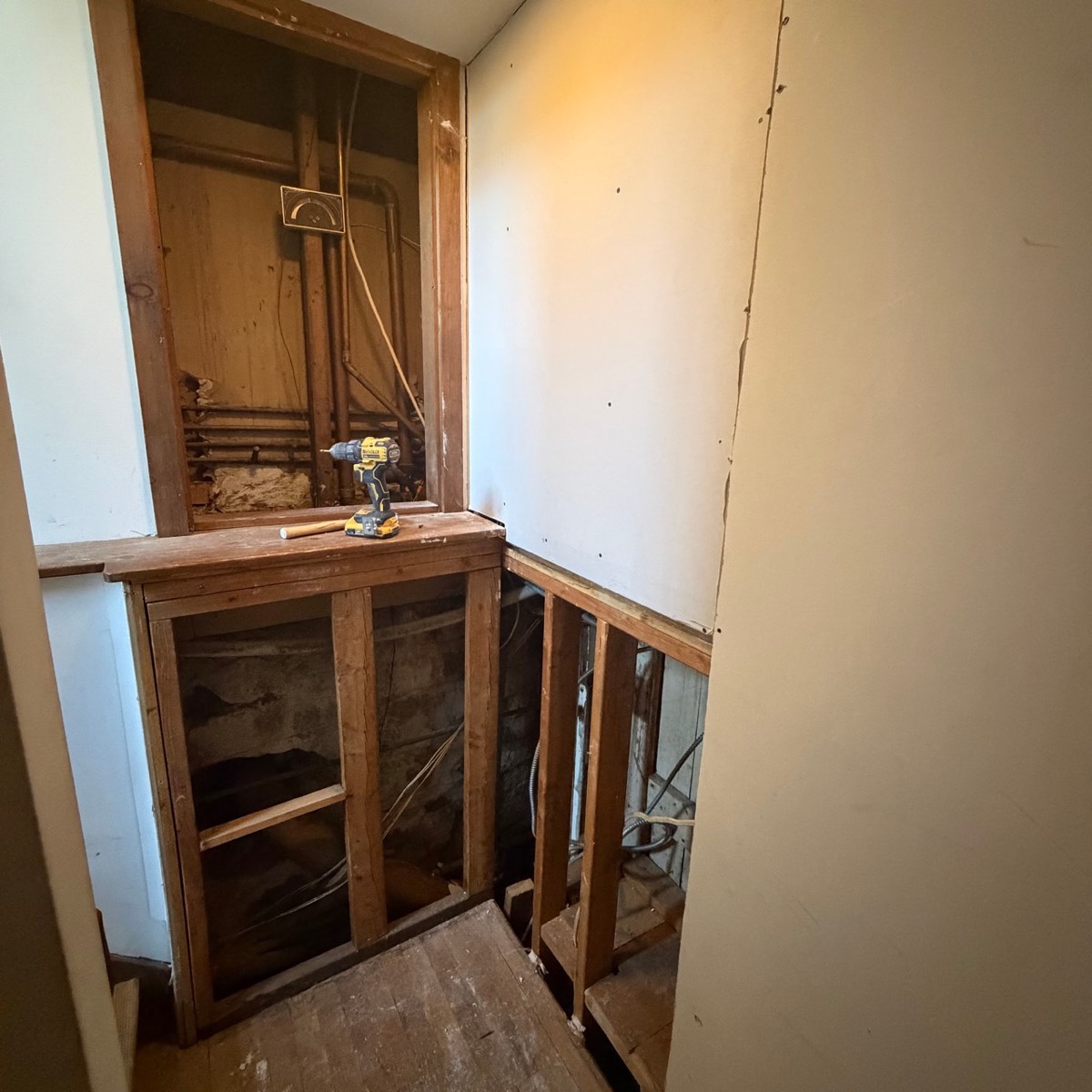 Before photo of stairwell wall opening before drywall repair in Ridgefield CT