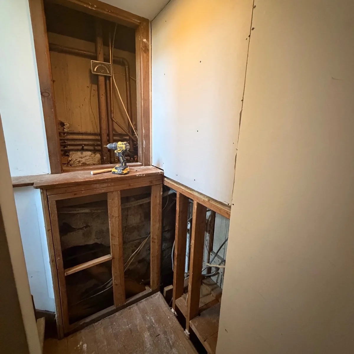 Before photo of stairwell wall opening before drywall repair in Ridgefield CT